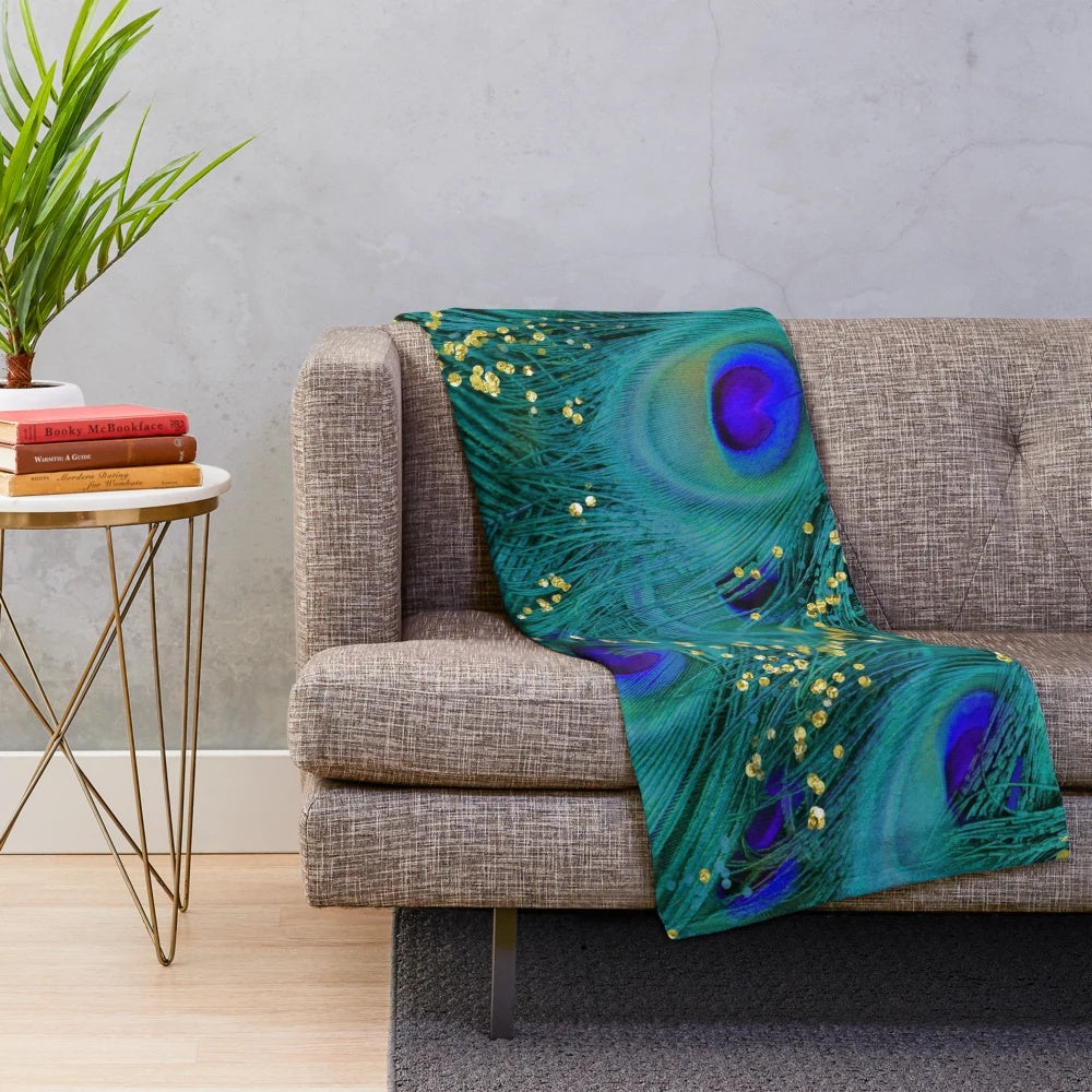 Plush blanket featuring a dreamy peacock feather design in teal, purple, and glimmering gold