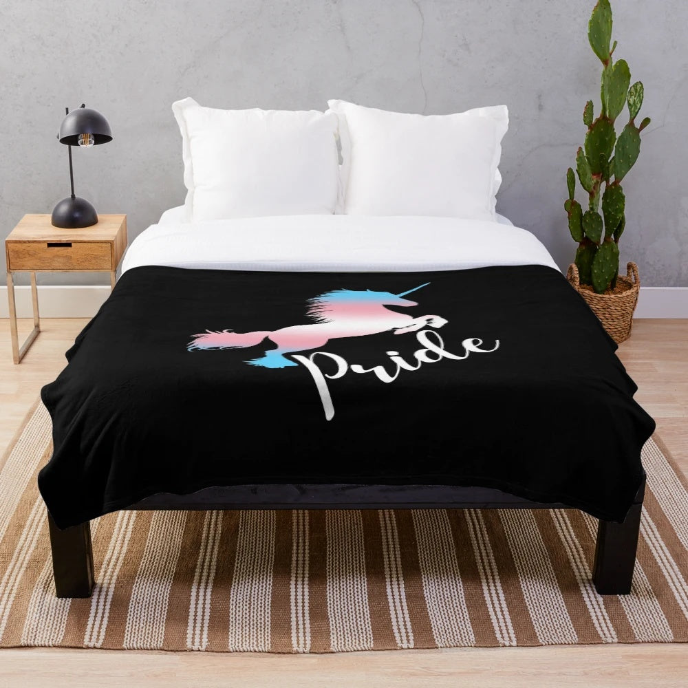 Cozy plush blanket featuring a unicorn in the colors of the transgender pride flag