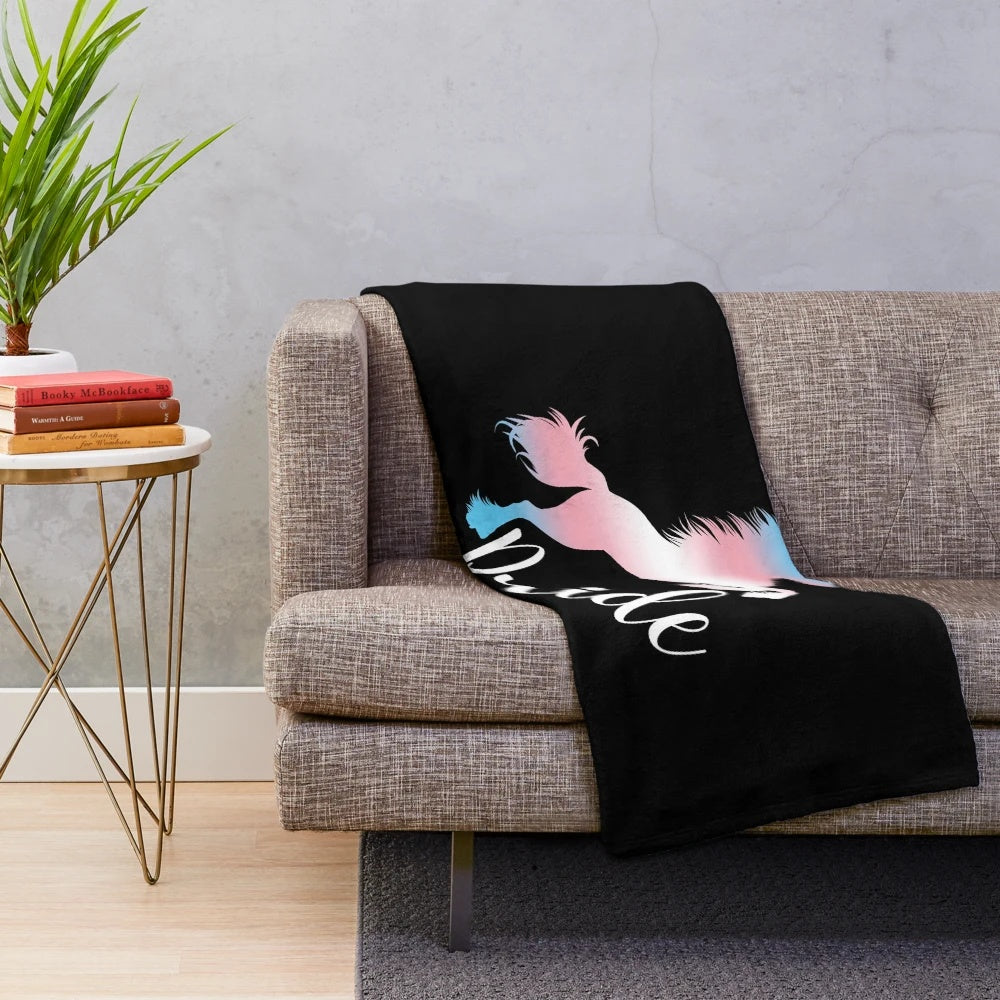Cozy plush blanket featuring a unicorn in the colors of the transgender pride flag