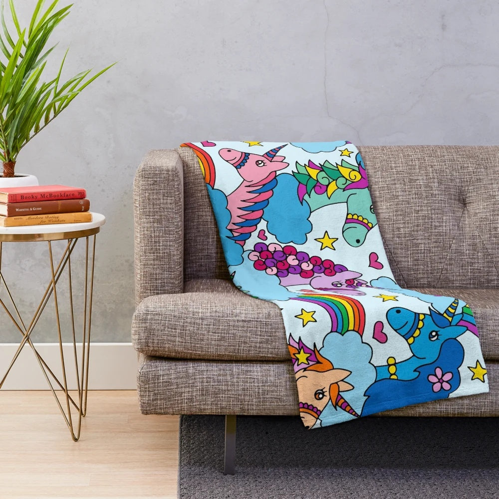 Colorful unicorn plush blanket with clouds and rainbows