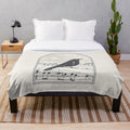 Plush black and white blanket with bird and music note design