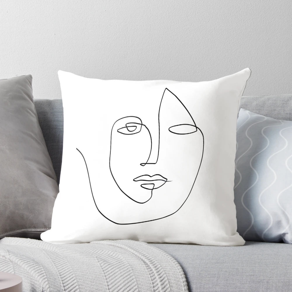 Minimalist abstract face design in one continuous line on a throw pillow