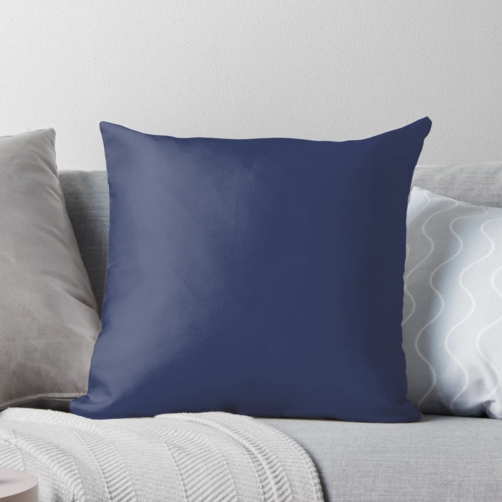 A simple, dark blue pillow with a plain, solid color design for a minimal, modern bedroom decor.
