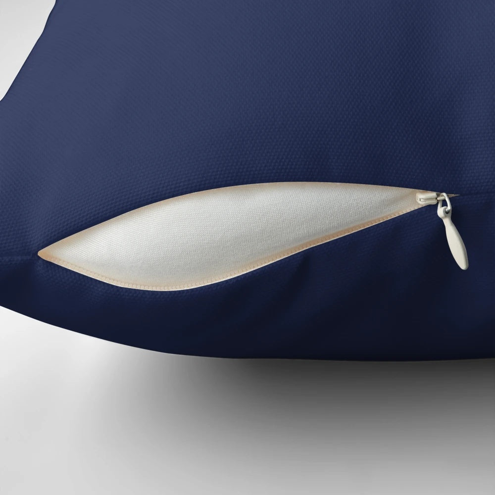 A simple, dark blue pillow with a plain, solid color design for a minimal, modern bedroom decor.