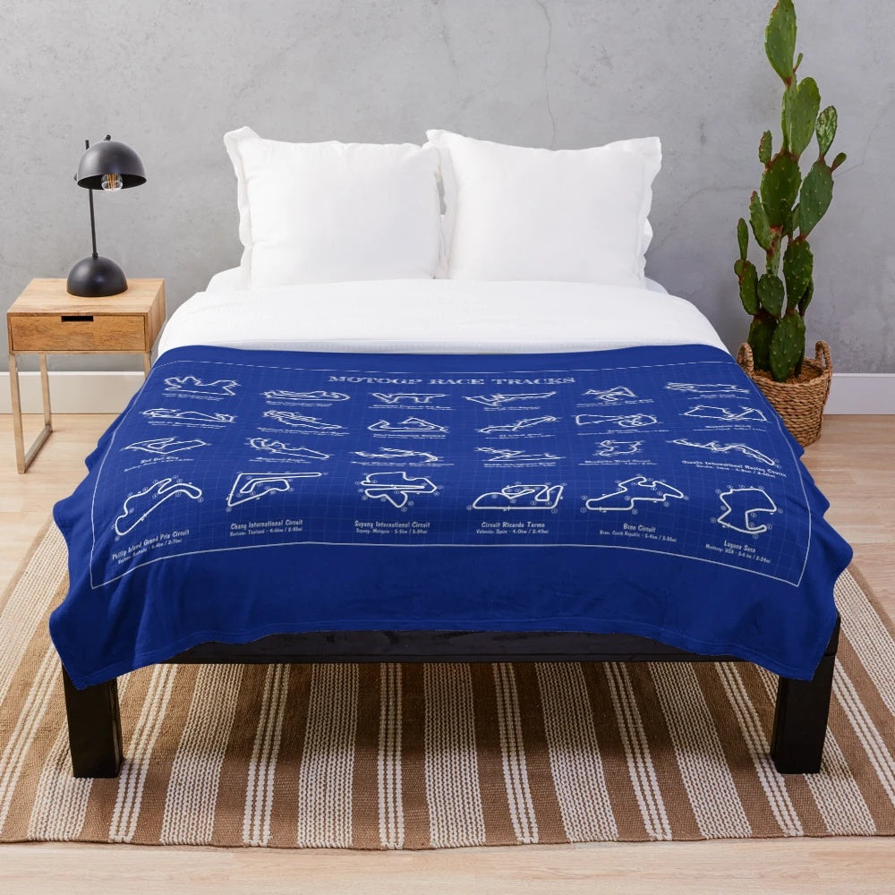Motorsports inspired plush blanket featuring a blueprint design of a MotoGP race track