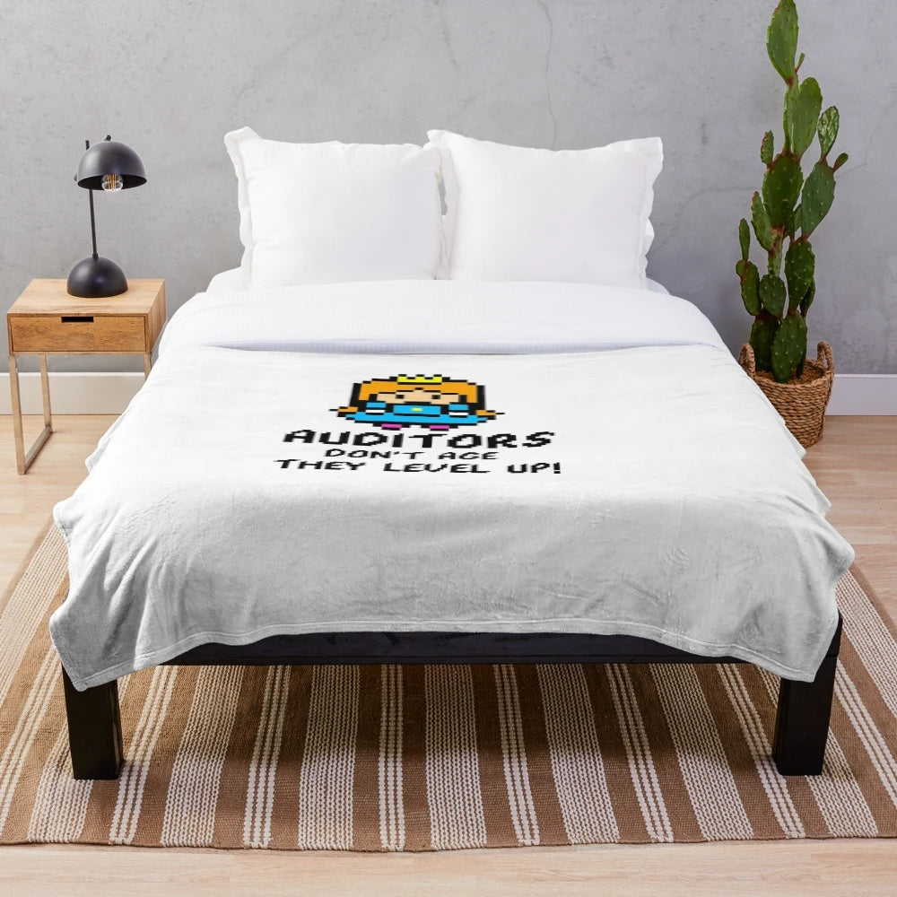 Plush blanket featuring an 8-bit style design with the text "Auditors don't age, they level up!