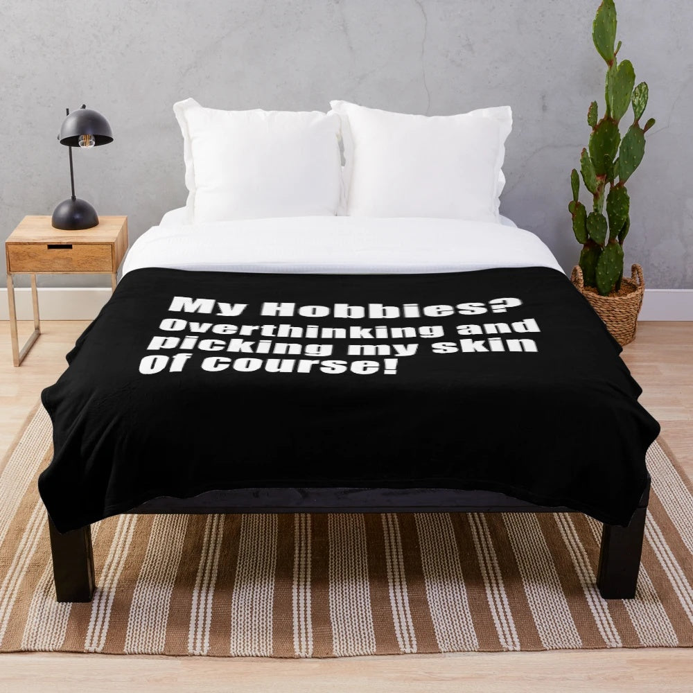 Plush blanket with the text "My hobbies overthinking and picking my skin of course