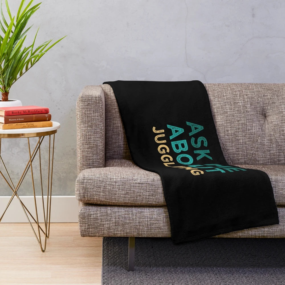 Plush blanket with "Ask Me About Juggling" design