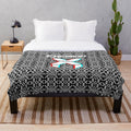 Plush blanket with vibrant electronic music festival-inspired pattern