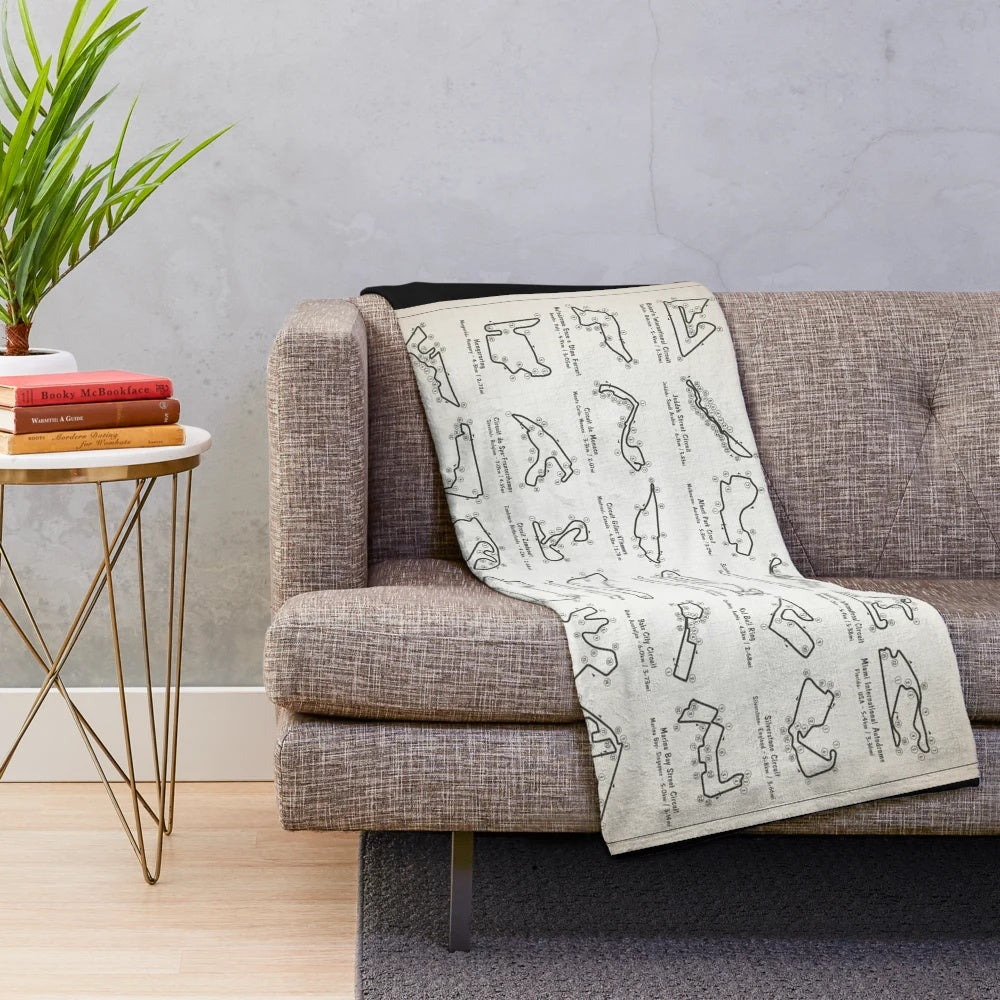 Plush throw blanket featuring a light ivory blueprint design of an F1 race track
