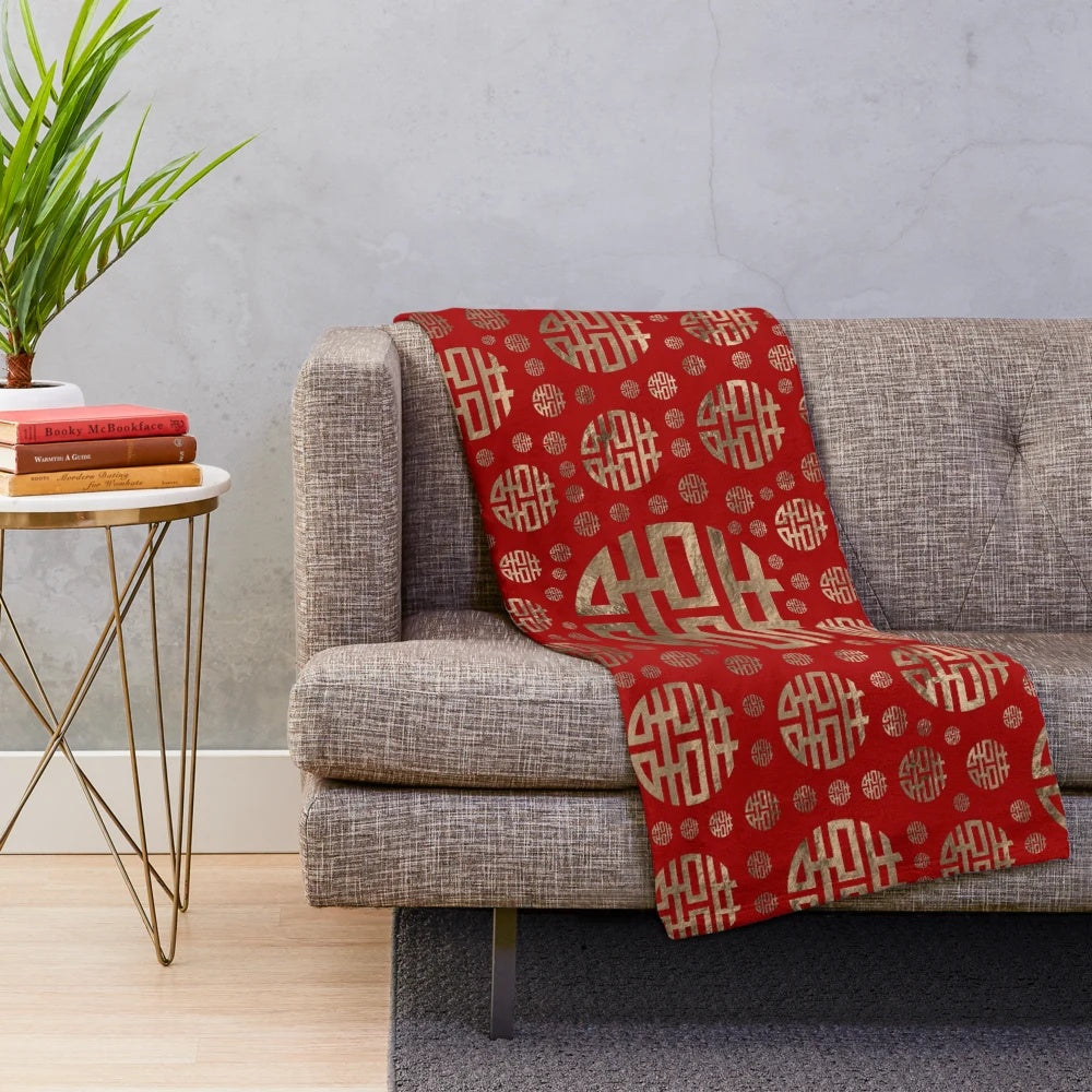Plush blanket featuring a traditional Chinese double happiness symbol pattern in gold on a red background