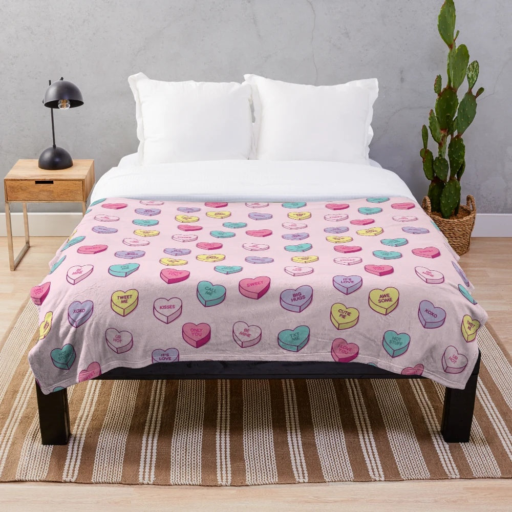 Soft and cozy plush blanket with a pastel conversation hearts pattern