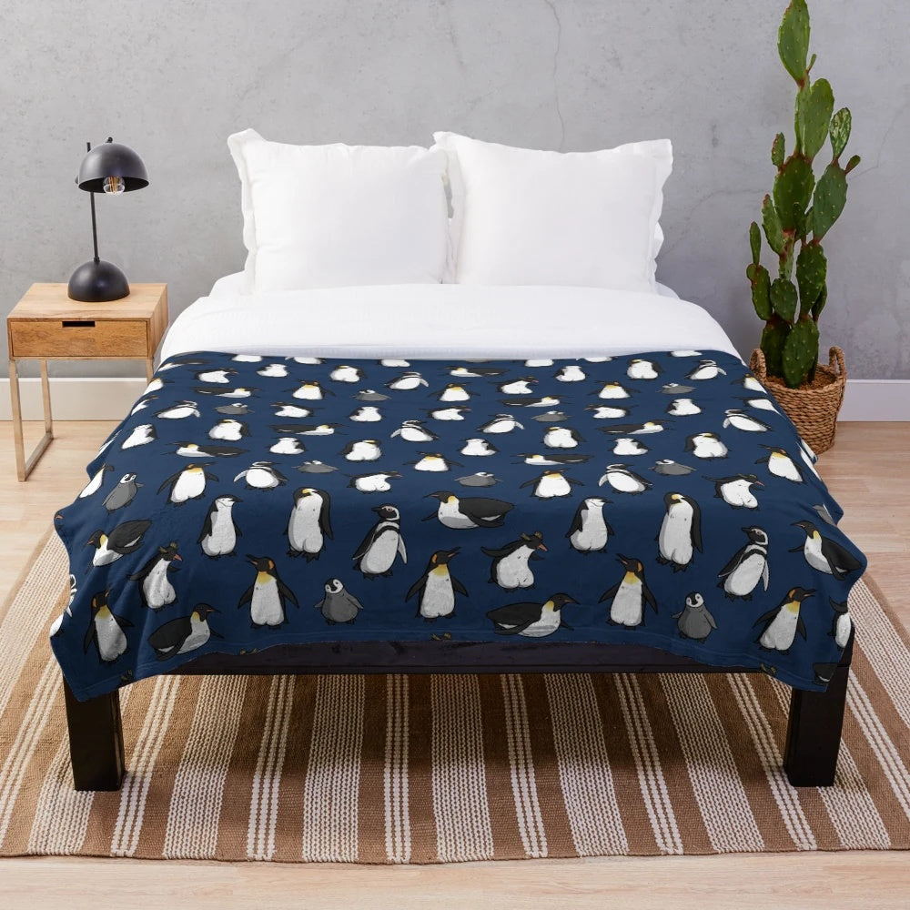 A cozy and cute plush blanket with a penguin pattern in dark blue