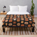 Pumpkin-patterned plush blanket with jack o'lanterns
