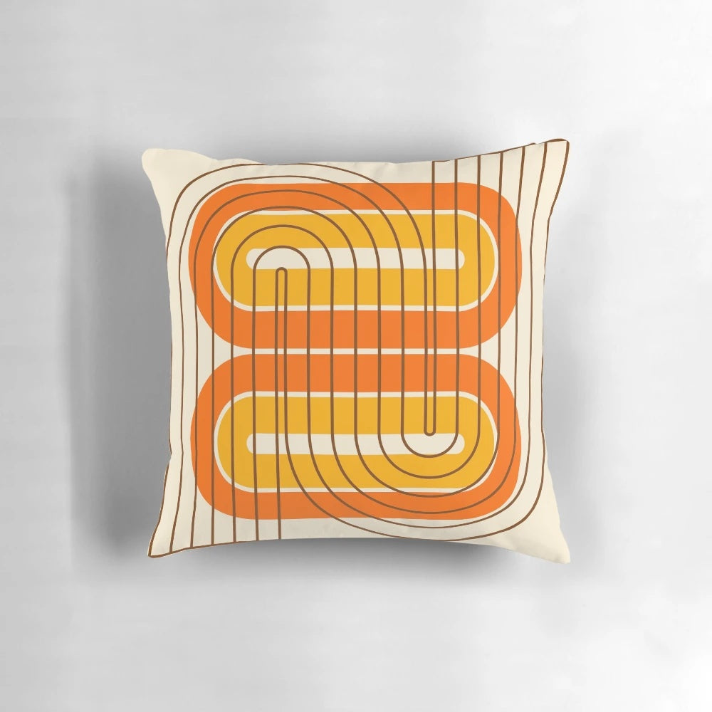 Vibrant retro geometric pattern pillow in orange, yellow, and brown tones for mid-century modern and 1970s inspired home decor.