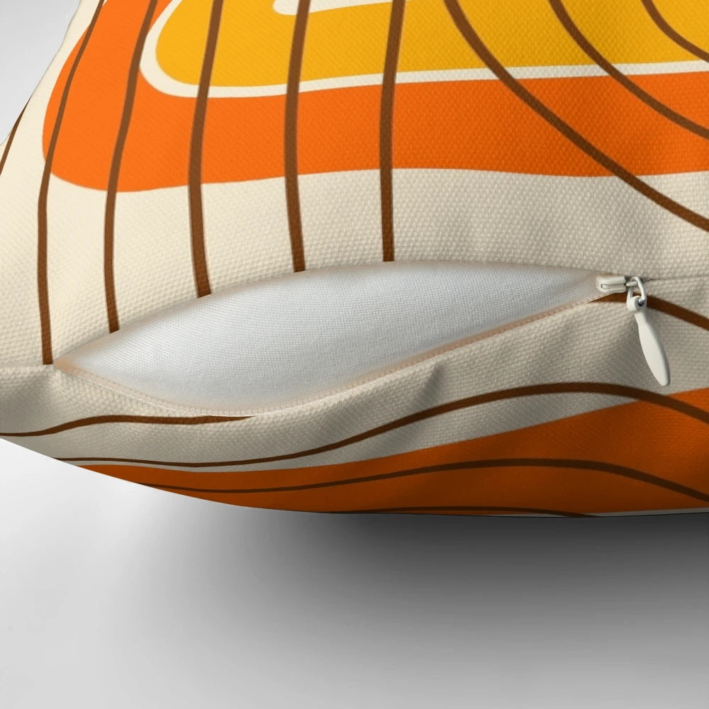 Vibrant retro geometric pattern pillow in orange, yellow, and brown tones for mid-century modern and 1970s inspired home decor.