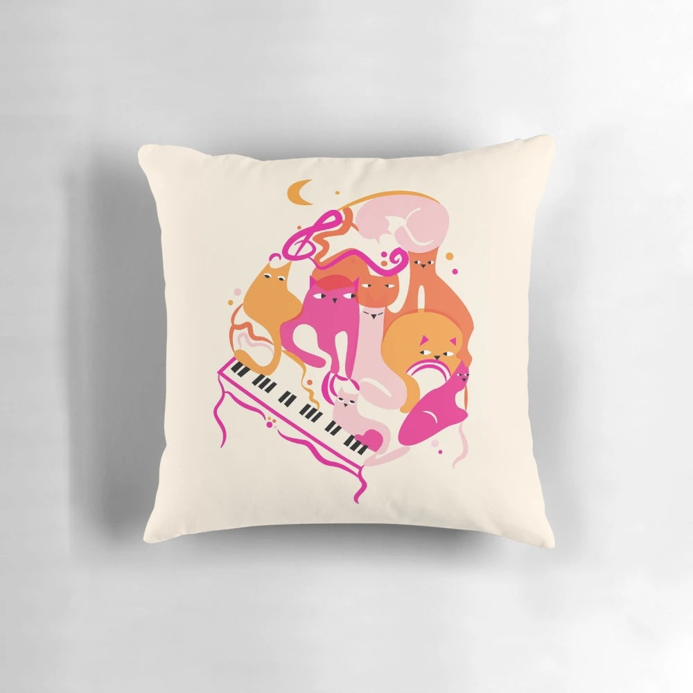 Vibrant pink and orange pillow with jazz cats and piano keys design