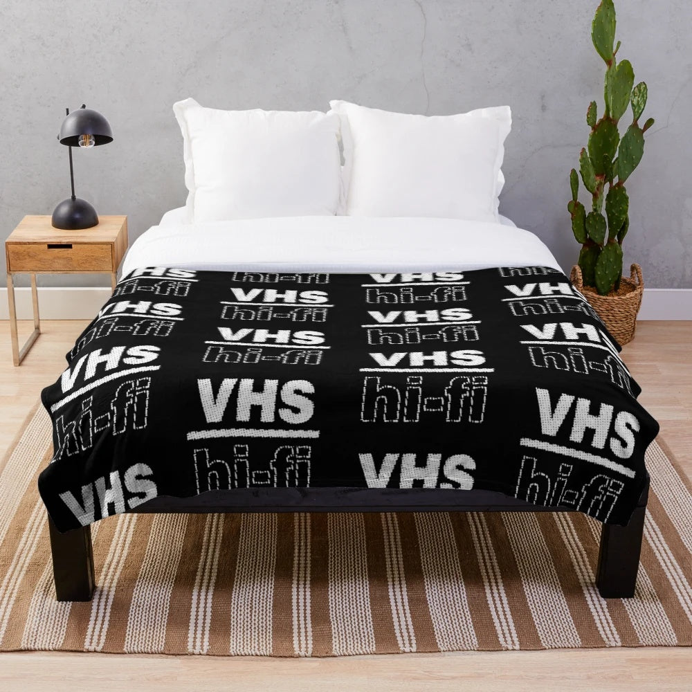 Plush blanket with retro VHS-inspired design