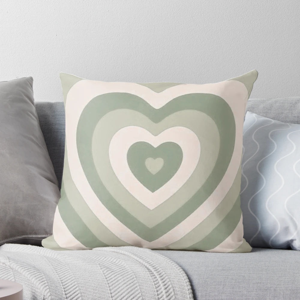Sage green heart-shaped pillow with a vintage, aesthetic design