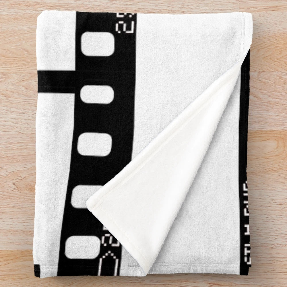 Retro vintage plush blanket featuring a film strip design in red, green, and blue colors