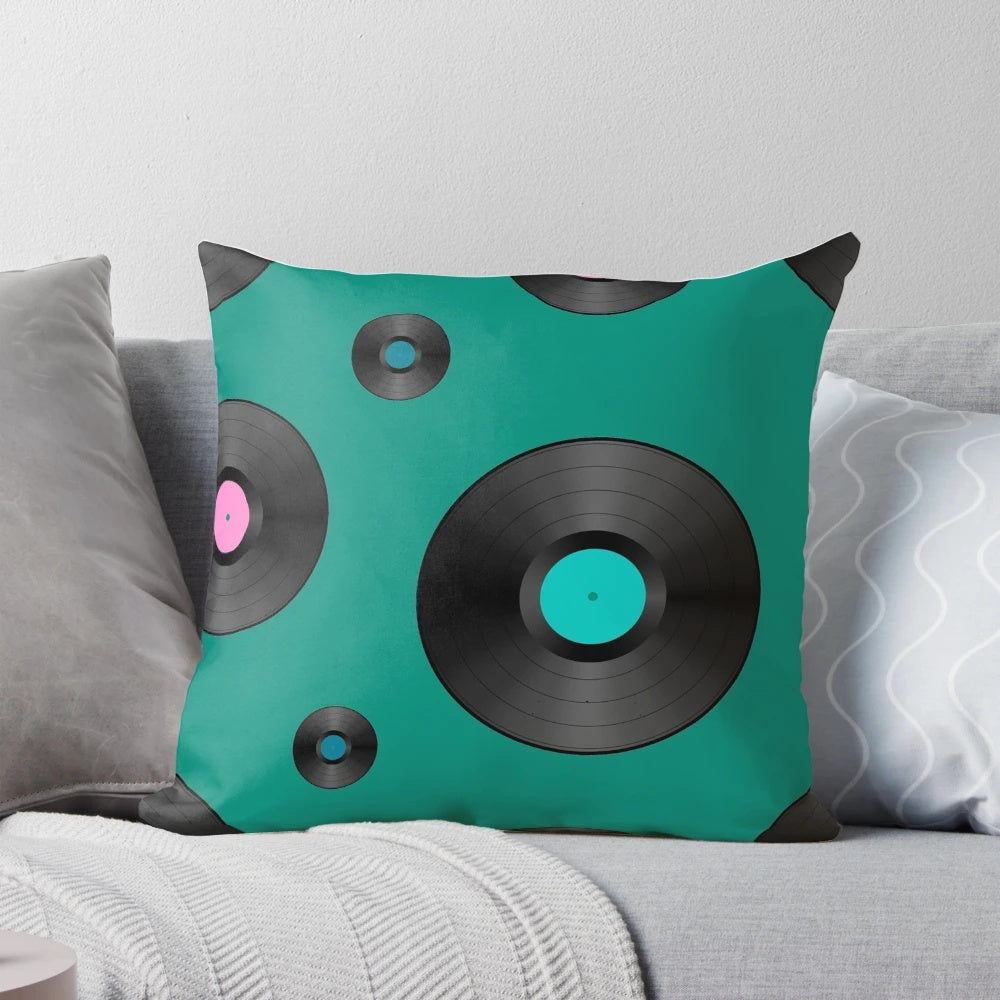 Colorful retro-style pillow featuring a vibrant pattern of vinyl records in pink, teal, and purple hues