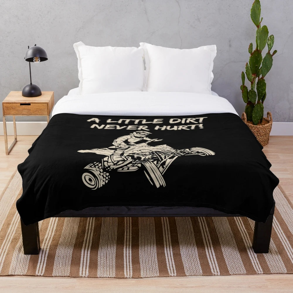 Plush blanket featuring an ATV quad racing design