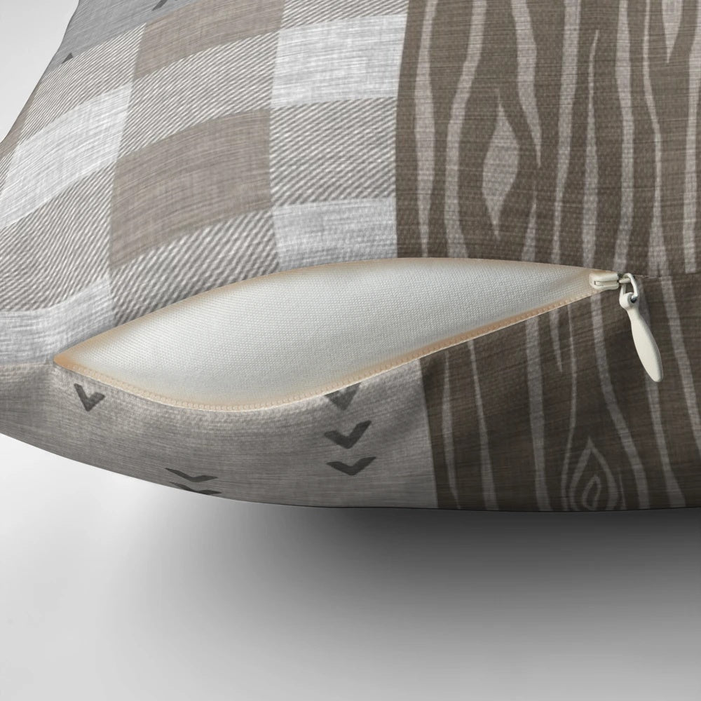 Rustic deer patchwork pattern pillow with neutral colors and woodland motifs