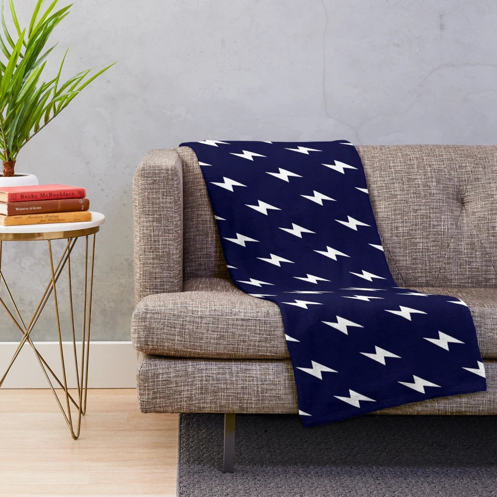 Navy blue plush blanket with white lightning bolt pattern