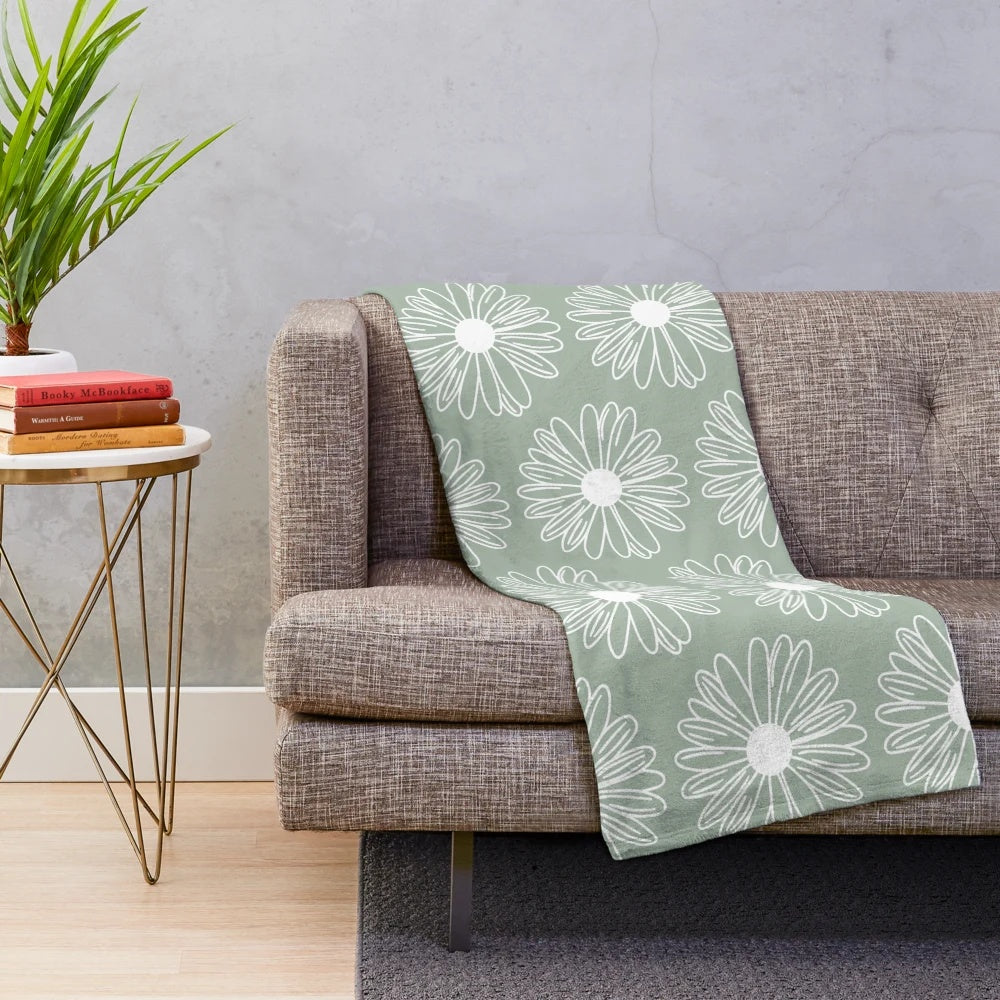 Soft and cozy sage green plush blanket with a beautiful floral daisy pattern