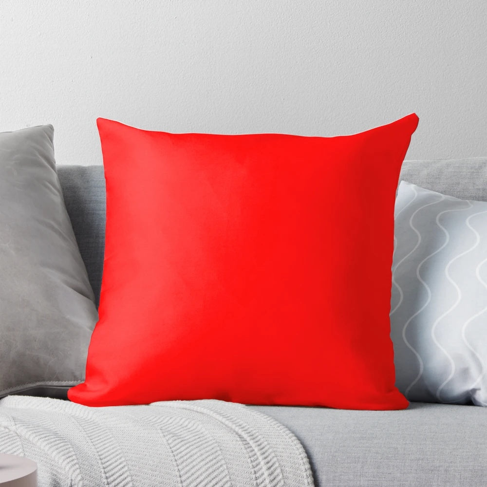 Solid red throw pillow with a variety of rich, vibrant red tones