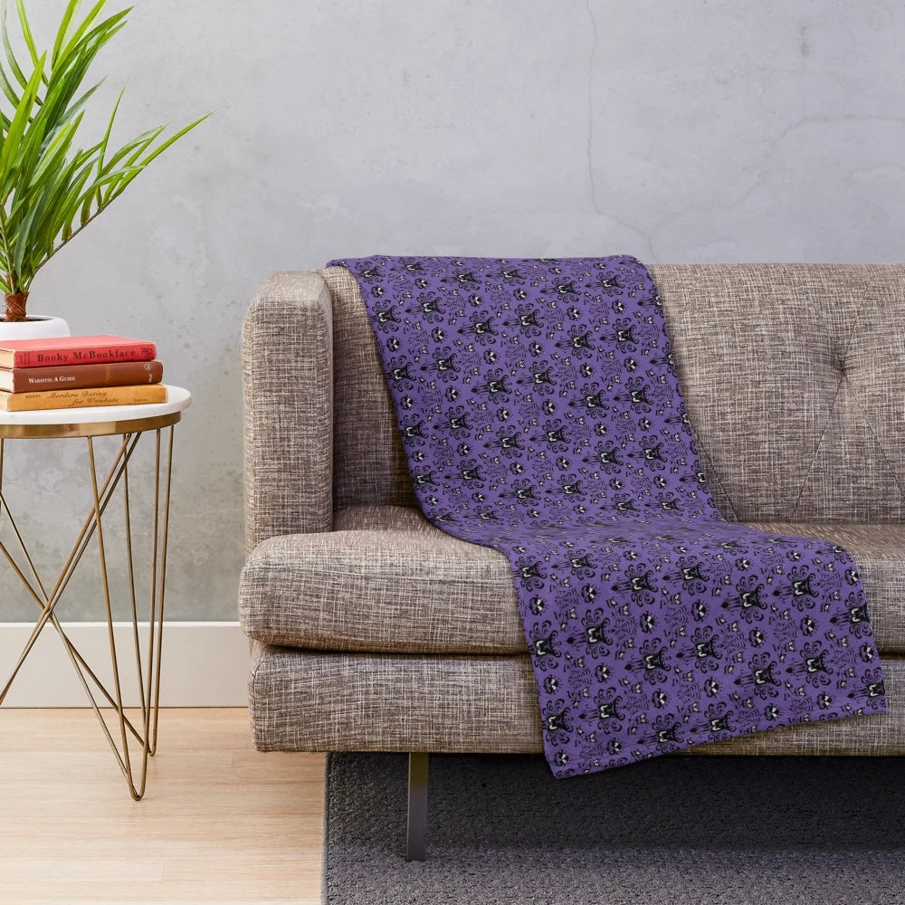 Haunted Mansion themed plush blanket with dark purple damask pattern