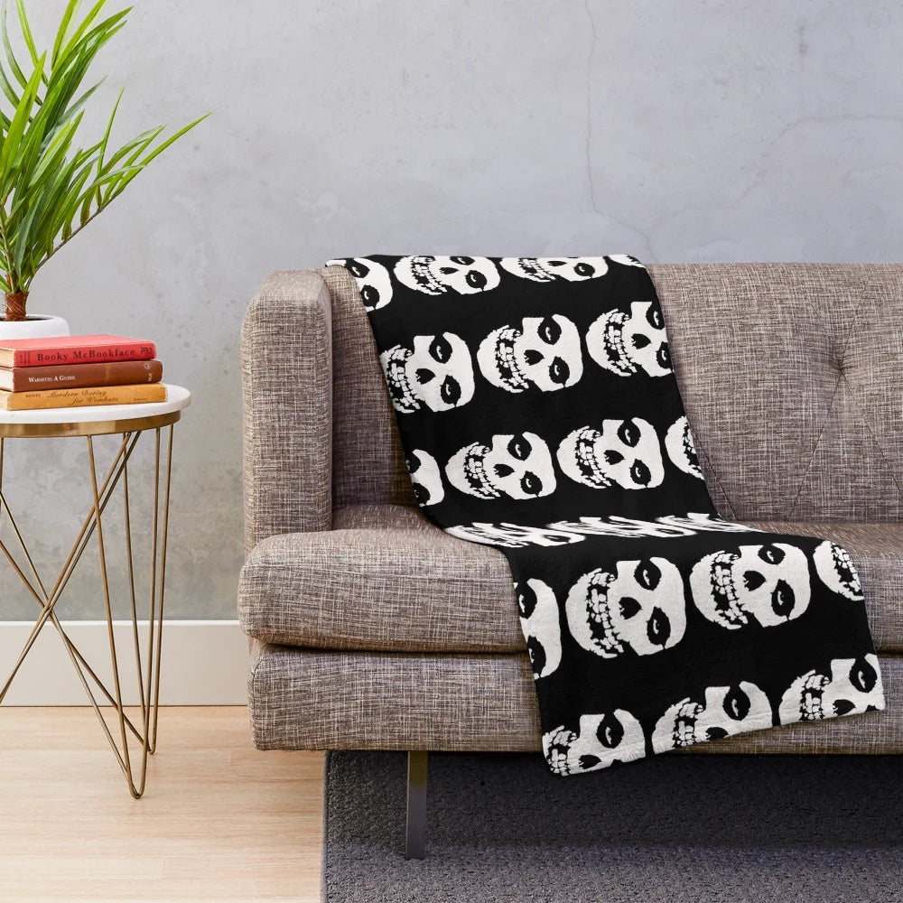 Misfits-inspired plush blanket with skull and logo design