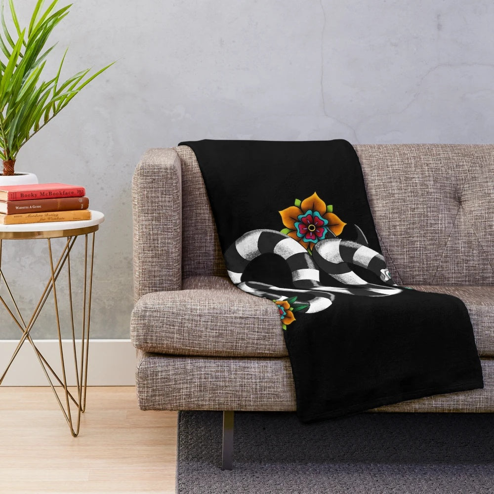 Sandworm plush blanket with a black and white floral design inspired by Tim Burton's iconic creature
