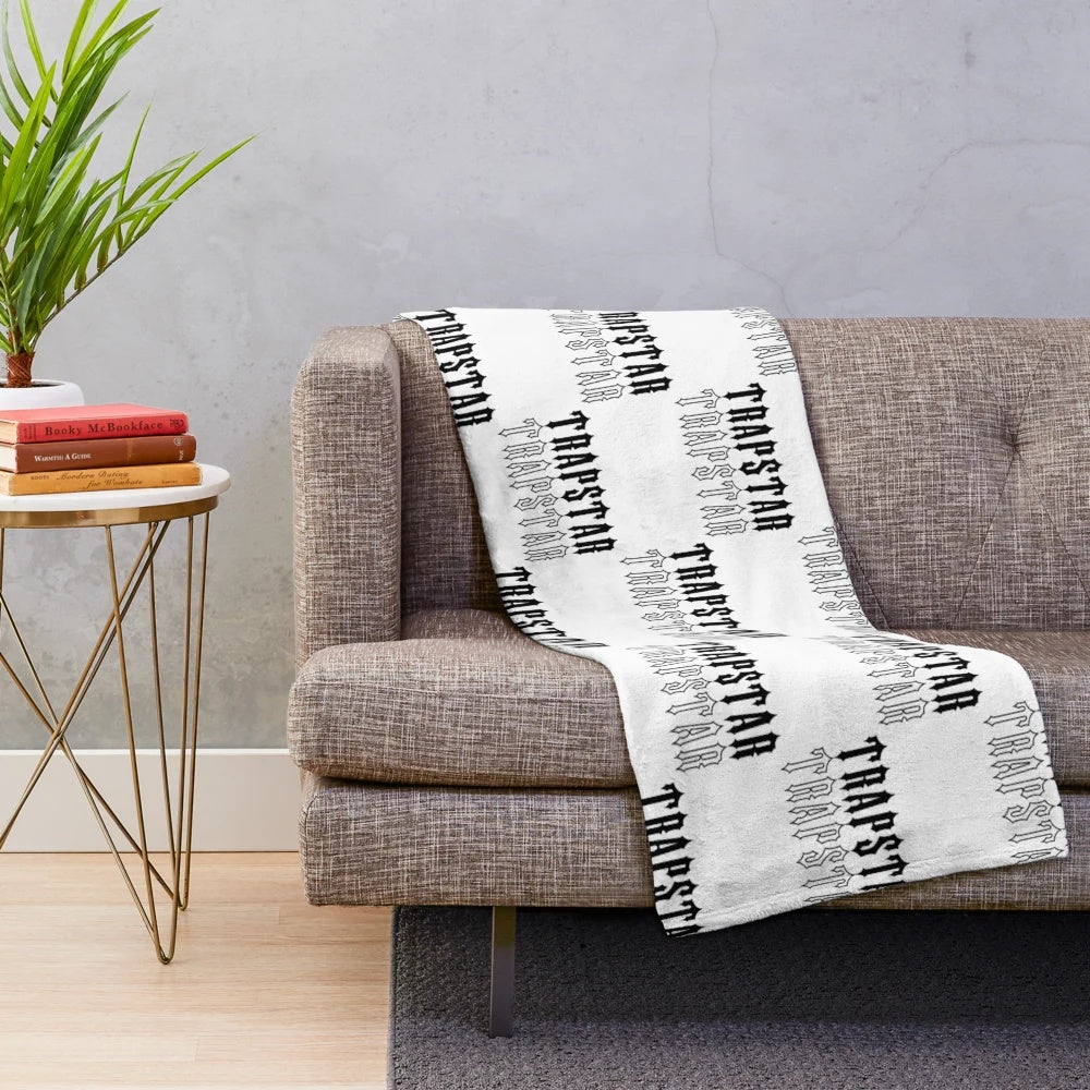 Black and white plush blanket with Trapstar-inspired design