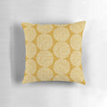 Gold, geometric, and bohemian-inspired pillow in a beige and brown color scheme.