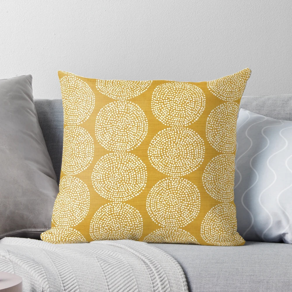 Gold, geometric, and bohemian-inspired pillow in a beige and brown color scheme.