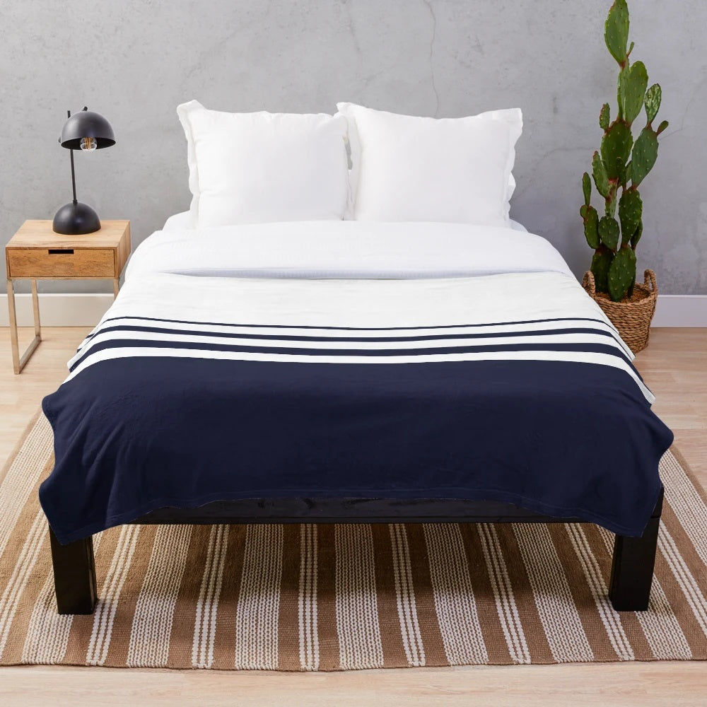 Navy and white striped plush blanket with a modern, minimalist design