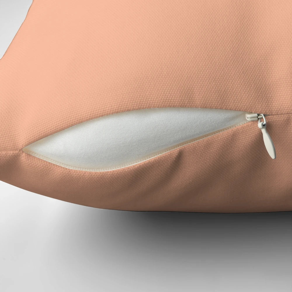 Peach-orange solid color pillow with a simple, minimalist design for bedroom decor.