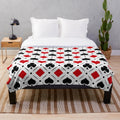 Plush blanket with playing card suits symbols and geometric patterns