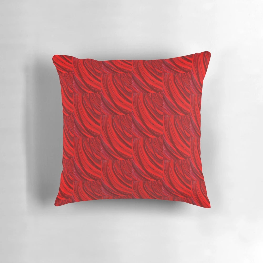 A red and maroon decorative pillow with abstract brush stroke patterns, perfect for adding a modern touch to any room.