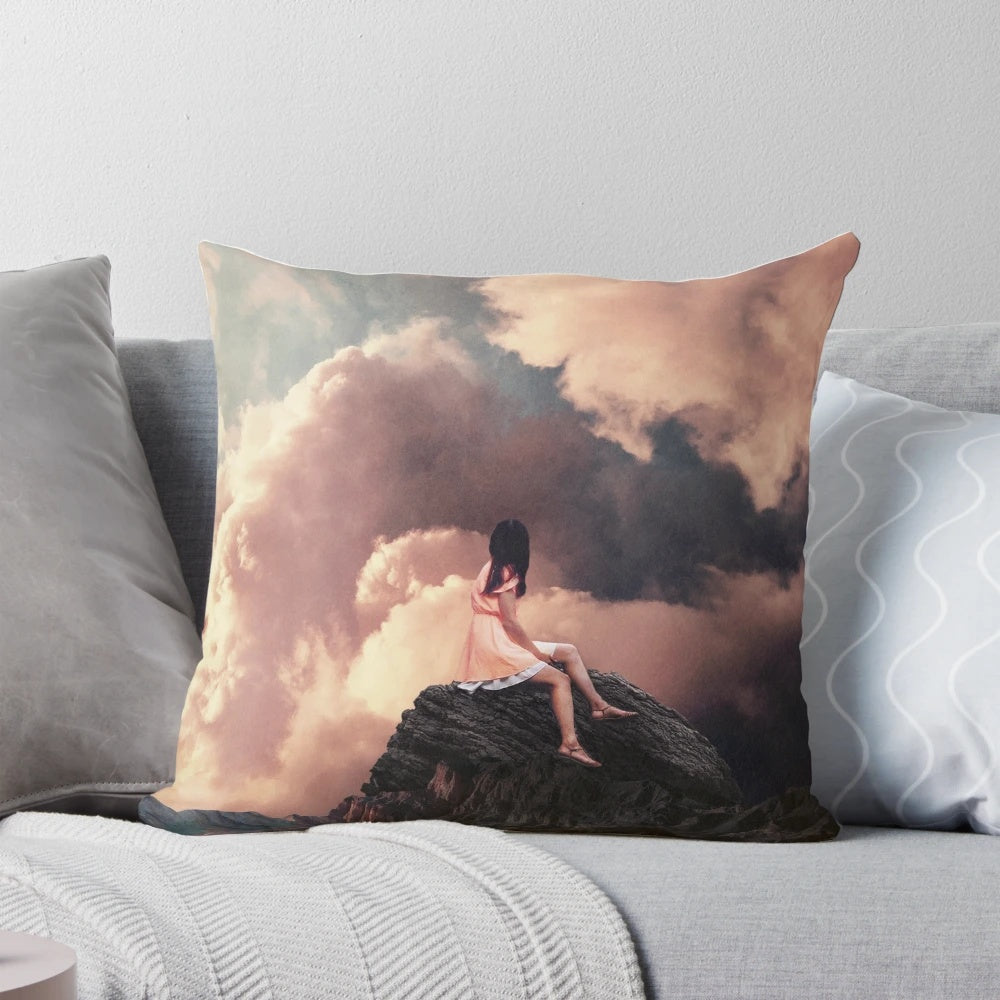 Surreal vintage-style pillow with a collage design of a woman in a landscape with mountains and clouds.