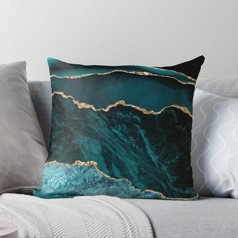 Teal and gold agate-inspired decorative pillow with a geode-like texture