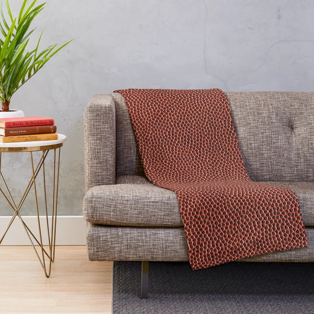 Soft, textured plush blanket with American football design