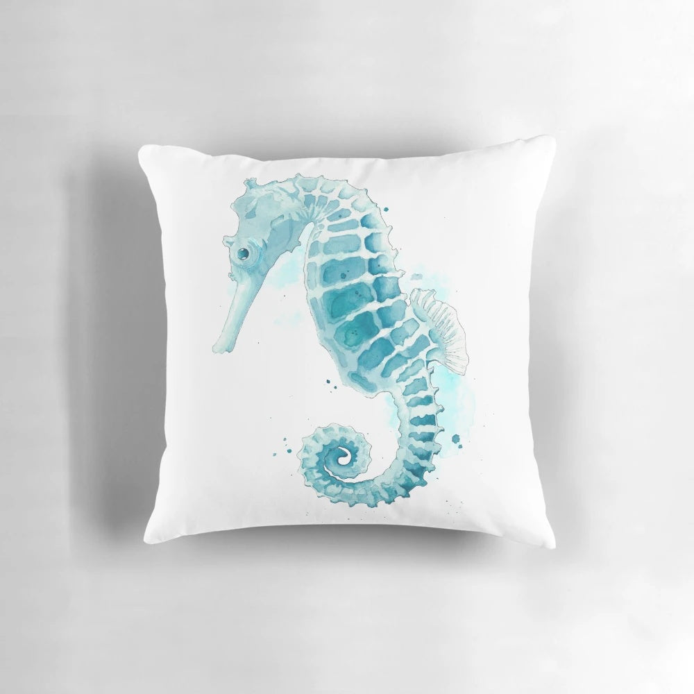 Watercolor painting of a seahorse on a decorative throw pillow for coastal home decor