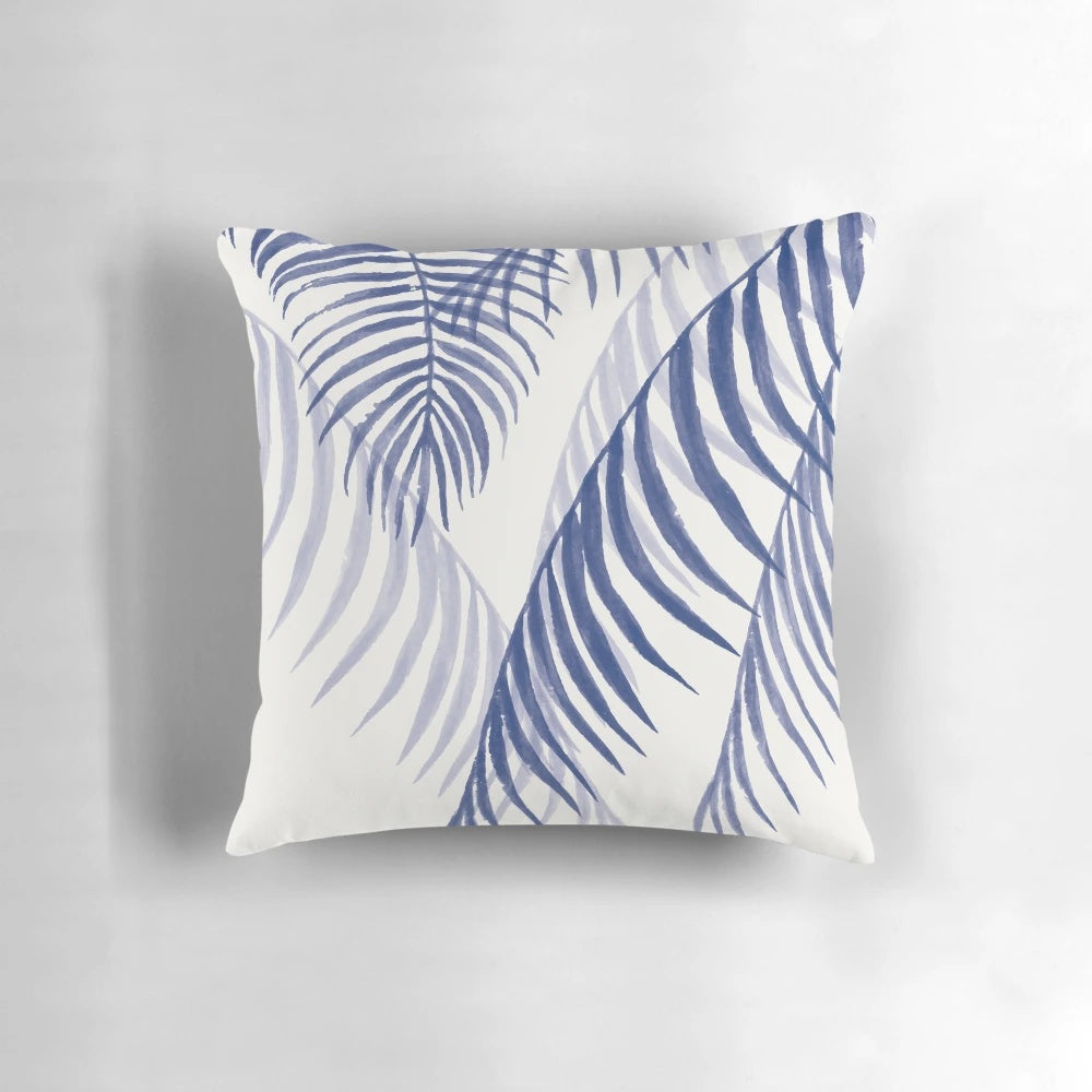 A decorative pillow featuring a vibrant tropical blue leaf pattern, perfect for adding a touch of nature-inspired style to any space.