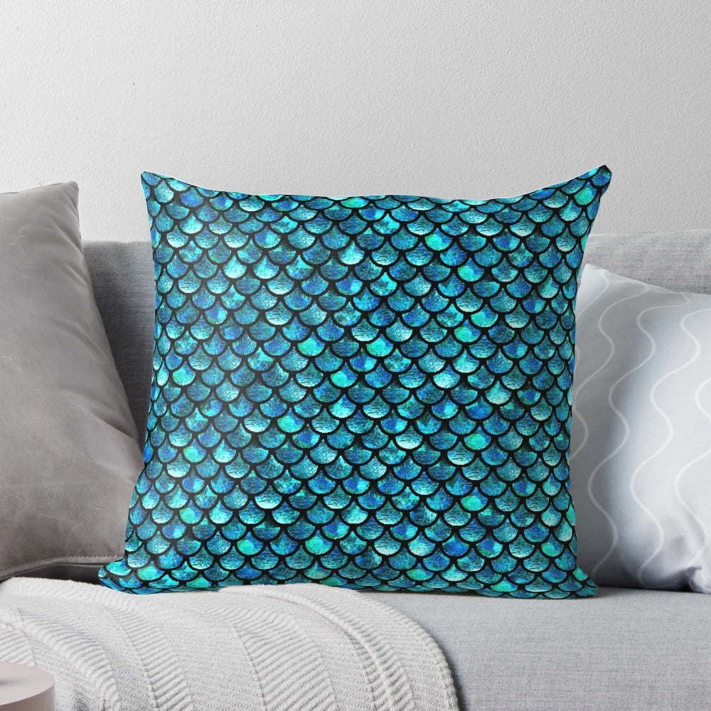 Turquoise blue pillow with mermaid scales pattern, perfect for adding a touch of the ocean to your home.