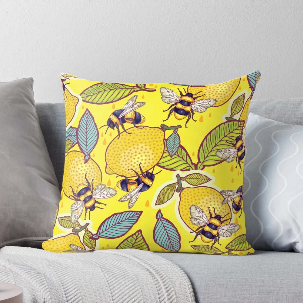 Colorful pillow with a design featuring a lemon, bees, and a garden scene