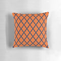 Moroccan-inspired orange and navy blue patterned pillow