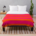 Neon pink and orange striped plush blanket