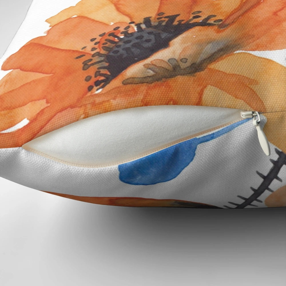 A colorful decorative pillow featuring an eye-catching orange and blue poppy design, perfect for adding a touch of nature-inspired beauty to any room.